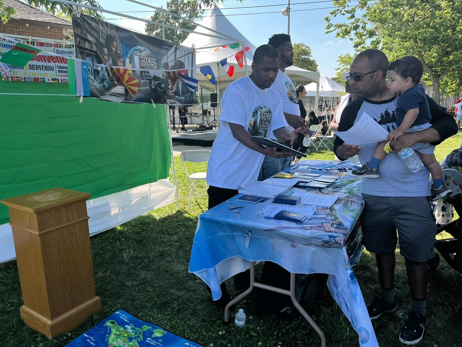 A GYLFH representative speaking with a family at a community event